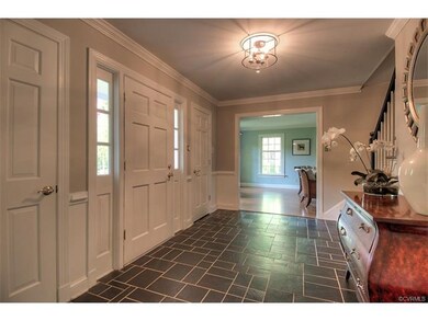 The home greets you with a charming foyer featurin