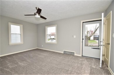 The front entry has a storm door and a coat closet