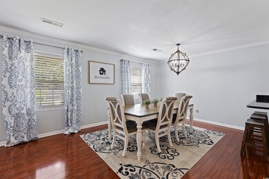 Dining area with a chandelier, hardwood / wood-sty
