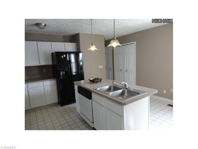 View of eat in kitchen w center island w/breakfast