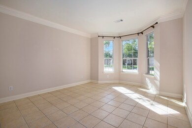 Formal living room with crown molding and tile flooring would also make a great home office.