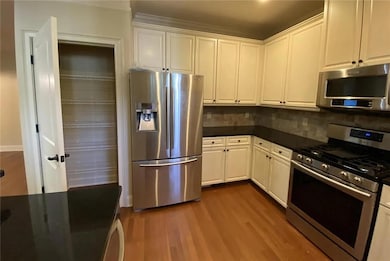 Unfurnished living room featuring dark wood-style flooring, a fireplace, ceiling fan, recessed lighting, and built in shelves