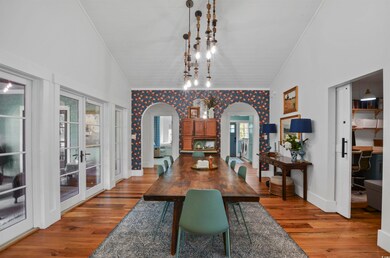 Dining space featuring crown molding, arched walkw
