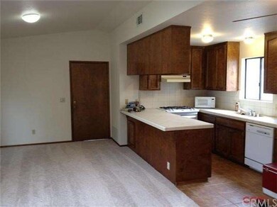 Kitchen has a breakfast bar, and is open to the li