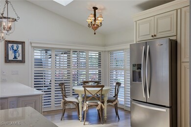 Dining area with an inviting chandelier, light woo