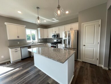 All photos of previously finished home of same floor plan -Granite countertops, stainless steel appliances, natural light and a full door pantry with shelves make working in the kitchen a delight.