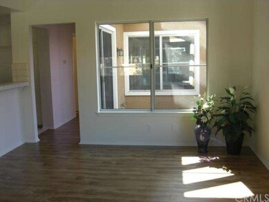 Living room adjacent to kitchen and balcony with n