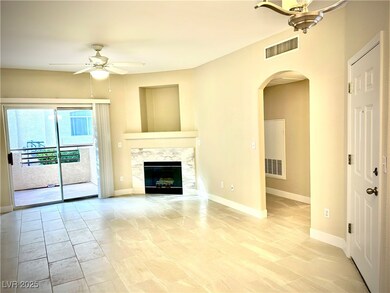 Unfurnished living room featuring arched walkways,