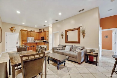Living area with light tile patterned flooring, recessed lighting, and baseboards