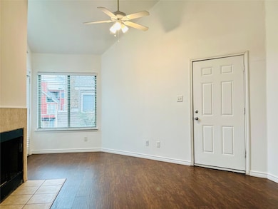 Unfurnished living room featuring baseboards, a ti