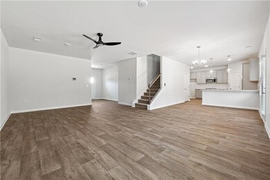 Unfurnished living room featuring ceiling fan with