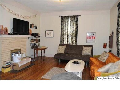 Living room with hardwood floors and fireplace #1.