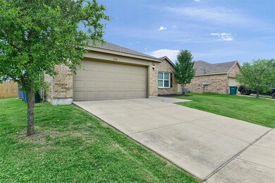 Ranch-style house with a garage and a front yard