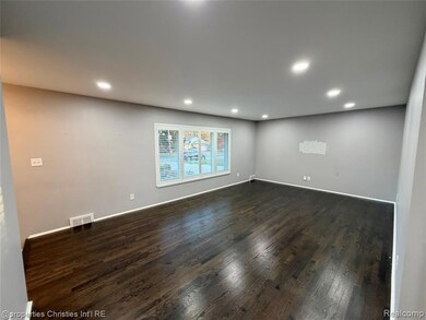 Empty room featuring recessed lighting and dark wood-style floors