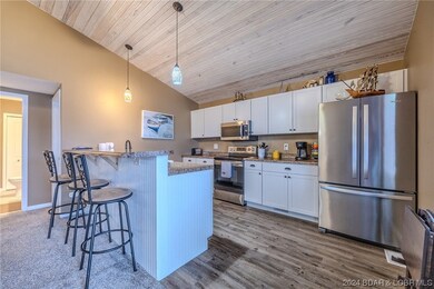 Kitchen, with Stainless steel appliances.