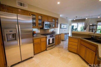 Stone flooring accents open kitchen.