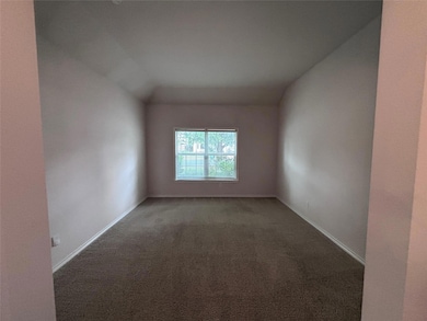 Unfurnished room with carpet flooring and vaulted