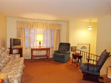 The living room overlooks the entry foyer, and sel
