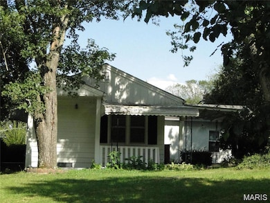 Back of property featuring a yard