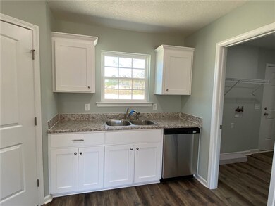 to the right is the laundry room with extra storag