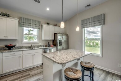 Kitchen featuring white cabinets, light wood-type 
