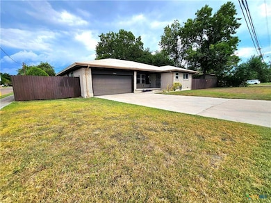 Ranch-style house featuring fence, a front yard, 