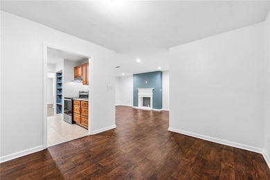 Unfurnished living room featuring light wood-type flooring, recessed lighting, and baseboards