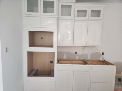 White stacked cabinets with glass front uppers - s