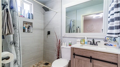 Bathroom with vanity and a shower stall