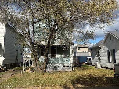 Back of house featuring a lawn and a deck