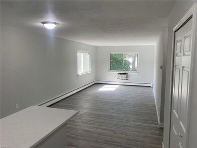 Wood floored spare room with a wall mounted air co