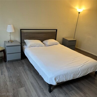 Bedroom with dark wood-style floors
