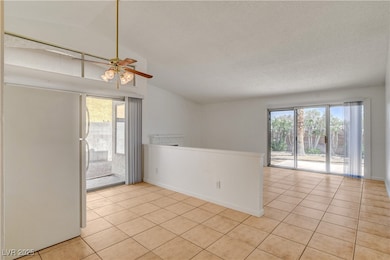 Unfurnished room featuring vaulted ceiling, light