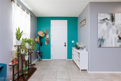 Entryway with light tile patterned floors and base