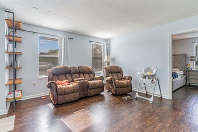 Living room featuring a textured ceiling and dark 