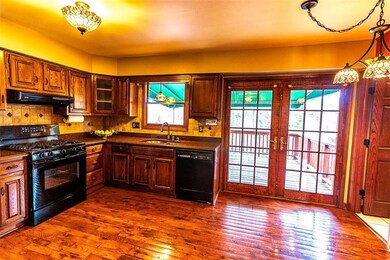 This large kitchen with wood cabinetry and granite