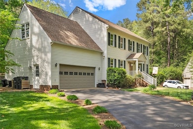 Colonial home with a front lawn, roof with shingle