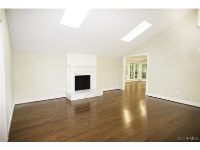 Living room with stunning marble fireplace, skylig