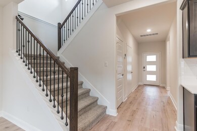 Foyer entrance with light wood-type flooring, bas