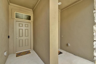 Property entrance featuring stucco siding