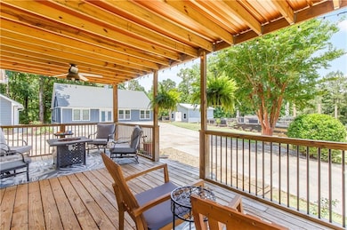 Wooden terrace featuring an outdoor living space with a fire pit