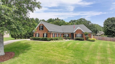 View of front of house with brick siding and a shingled roof