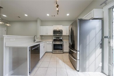 Kitchen featuring stainless steel appliances, ligh