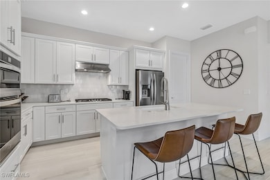 Kitchen with a breakfast bar area, stainless steel