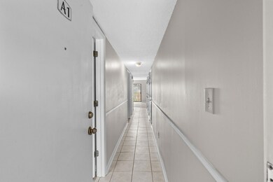 Corridor featuring light tile patterned flooring a