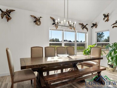 Dining space with wood-type flooring, vaulted ceil