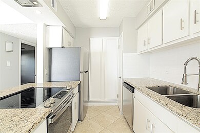 Kitchen has granite counters and electric range. Refrigerator is included.
