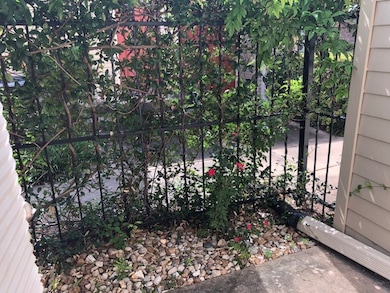 Out the French doors from living room leads you to a small iron fence enclosed patio that is ideal for a small
afternoon or evening gathering.