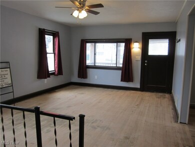 Foyer with light hardwood / wood-style floors and ceiling fan