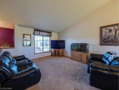 The living room features a vaulted ceiling. The fl